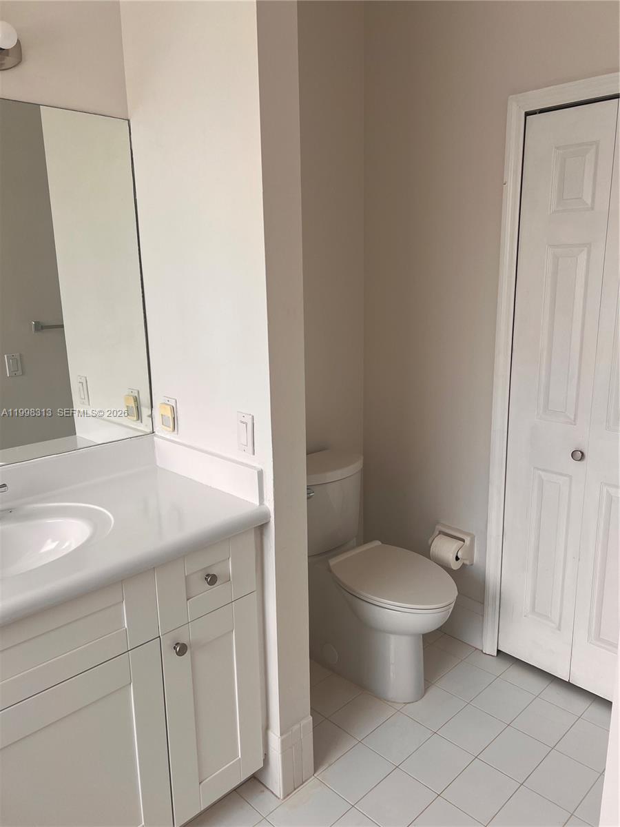 15761 Southwest 148th Terrace Miami, FL 33196 - Photo 15 of 17 a bathroom with a granite countertop toilet and a sink