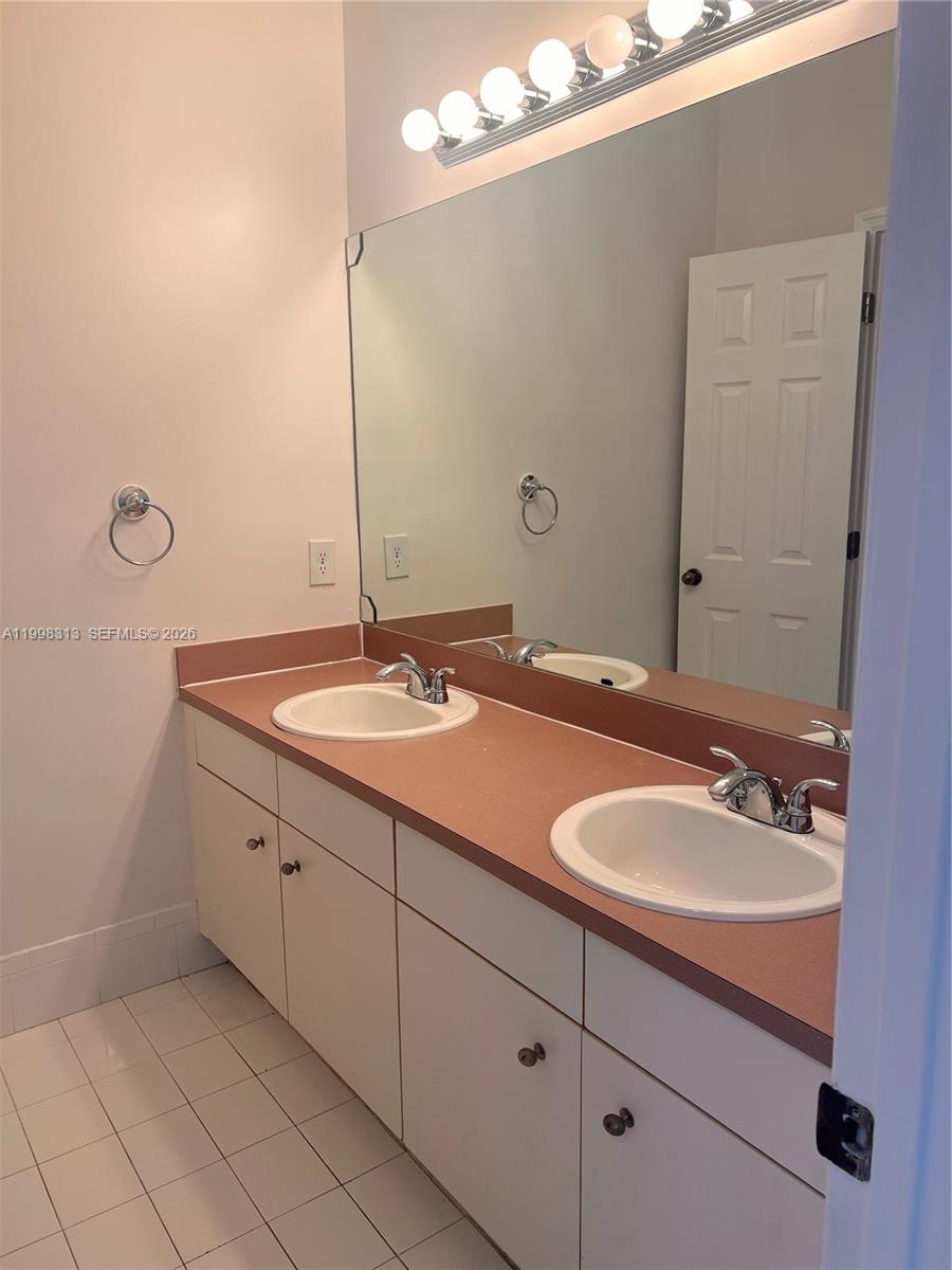 15761 Southwest 148th Terrace Miami, FL 33196 - Photo 7 of 17 a bathroom with a sink and a mirror