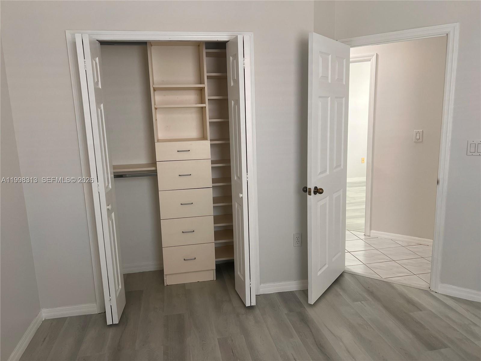 15761 Southwest 148th Terrace Miami, FL 33196 - Photo 10 of 17 an empty room with wooden floor closet and windows