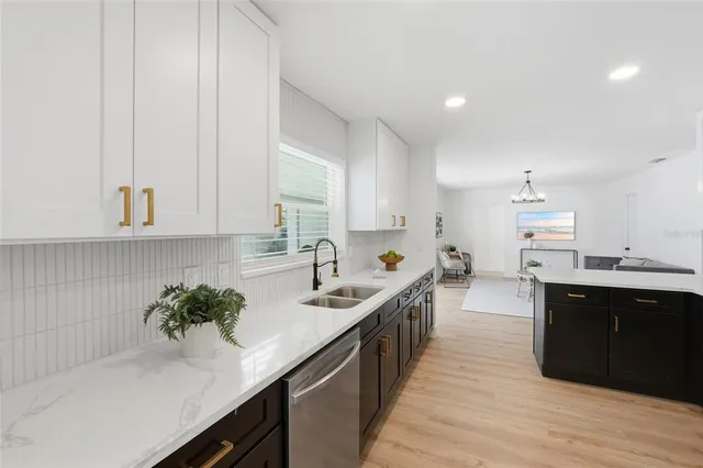 a kitchen with stainless steel appliances granite countertop a sink stove and cabinets