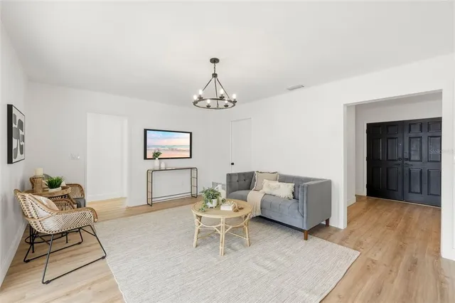 a living room with furniture and a chandelier