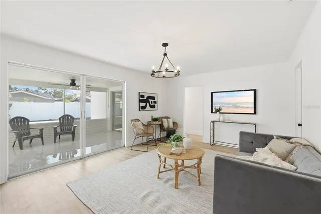 a living room with furniture and a chandelier