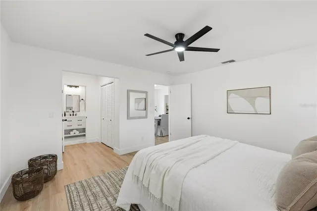 a bedroom with a bed and a painting on the wall