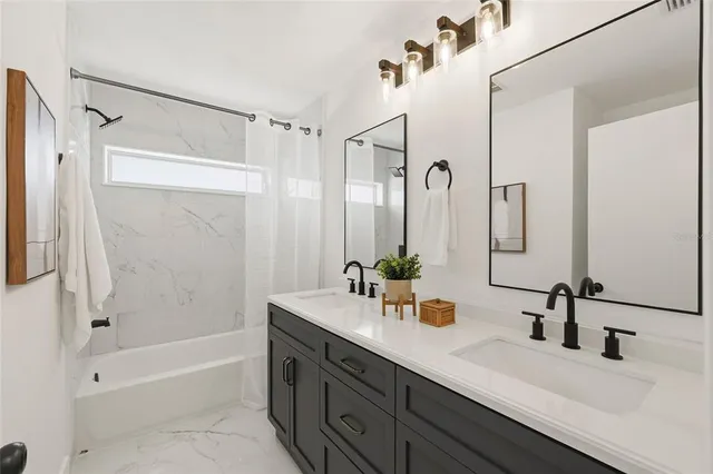 a bathroom with a double vanity sink mirror double and shower