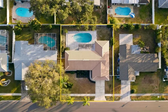 an aerial view of a house with a swimming pool
