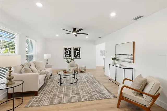 a living room with furniture and a wooden floor