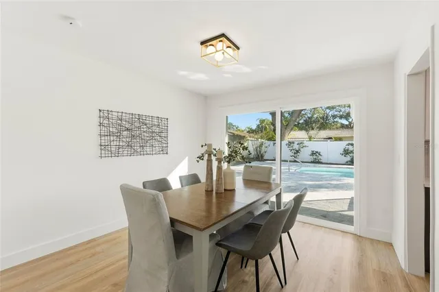 a dining room with furniture a rug and wooden floor