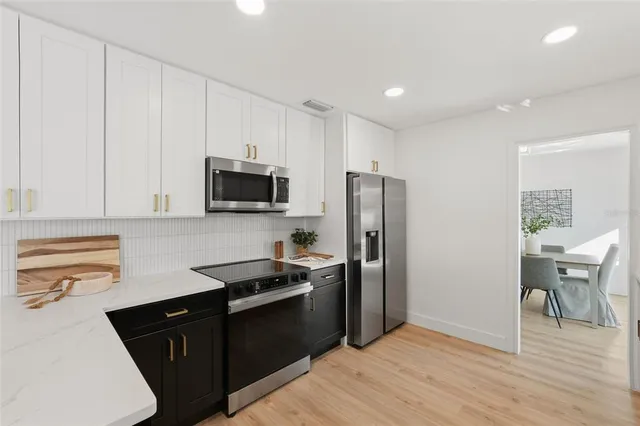 a kitchen with a refrigerator stove and microwave