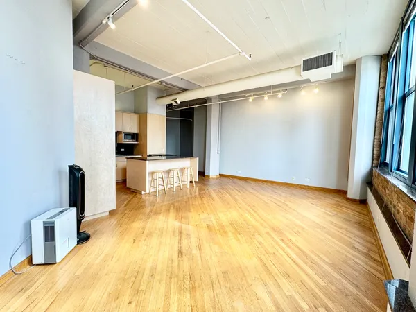 a view of a kitchen with wooden floor