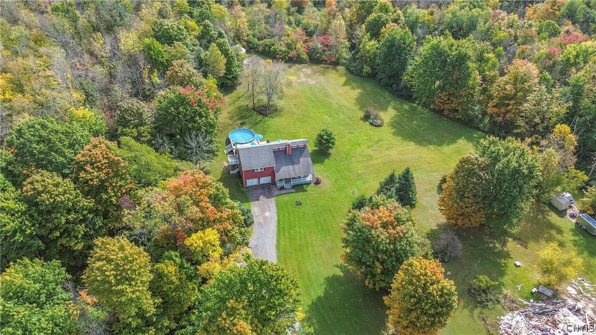 15384 Fuller Road Adams, NY 13606 - Photo 17 of 50 Mature woodlands frame a sprawling green lawn and a private country home.