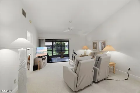 a bed room with furniture and a large window
