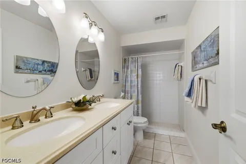 a bathroom with a sink double vanity and a mirror