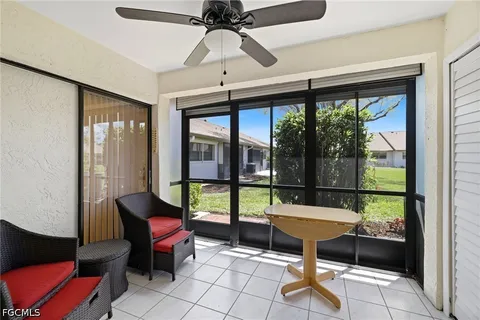 a living room with furniture and a floor to ceiling window