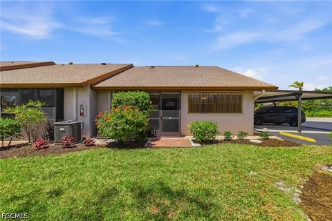 a view of a house with sitting area and garden