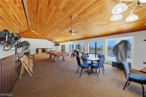 an aerial view of residential houses with outdoor space and ocean view