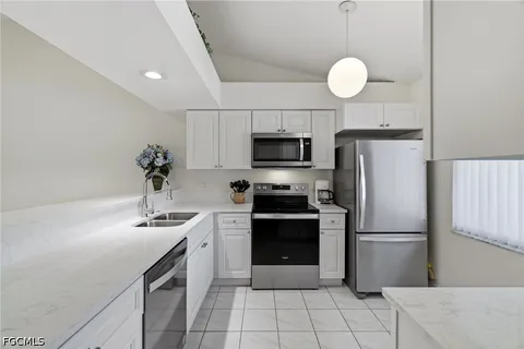 a kitchen with a sink stainless steel appliances and cabinets