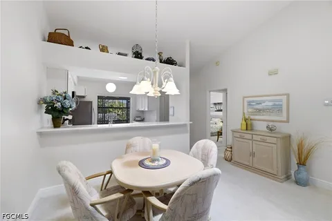 a view of a dining room with furniture and chandelier