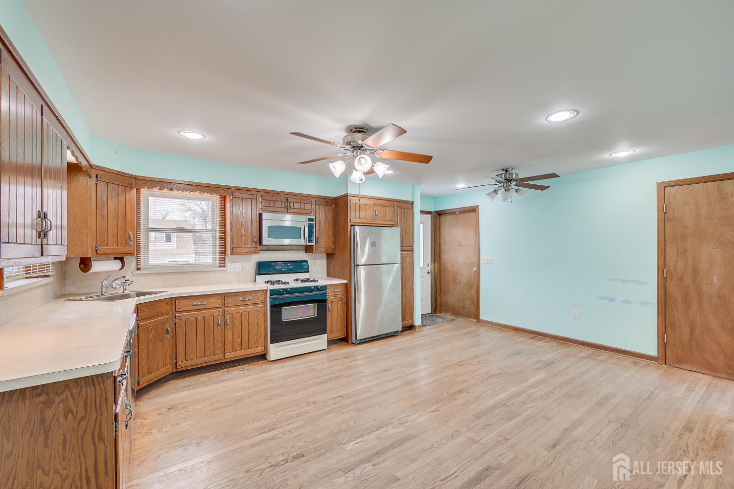 20 Longfield Road New Brunswick, NJ 08901 - Photo 14 of 32 a view of a kitchen center island wooden floor and stainless steel appliances