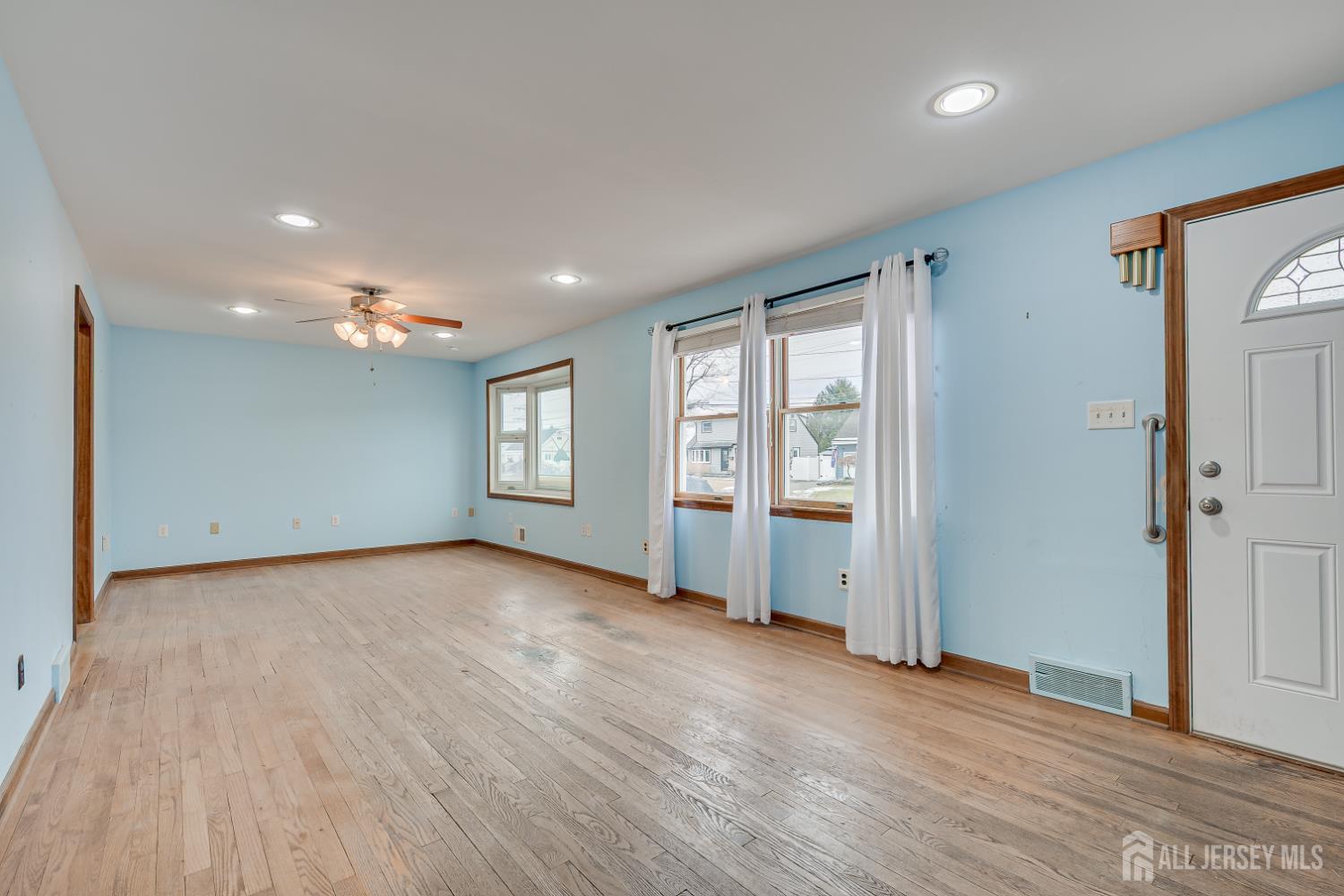 20 Longfield Road New Brunswick, NJ 08901 - Photo 8 of 32 an empty room with wooden floor and window