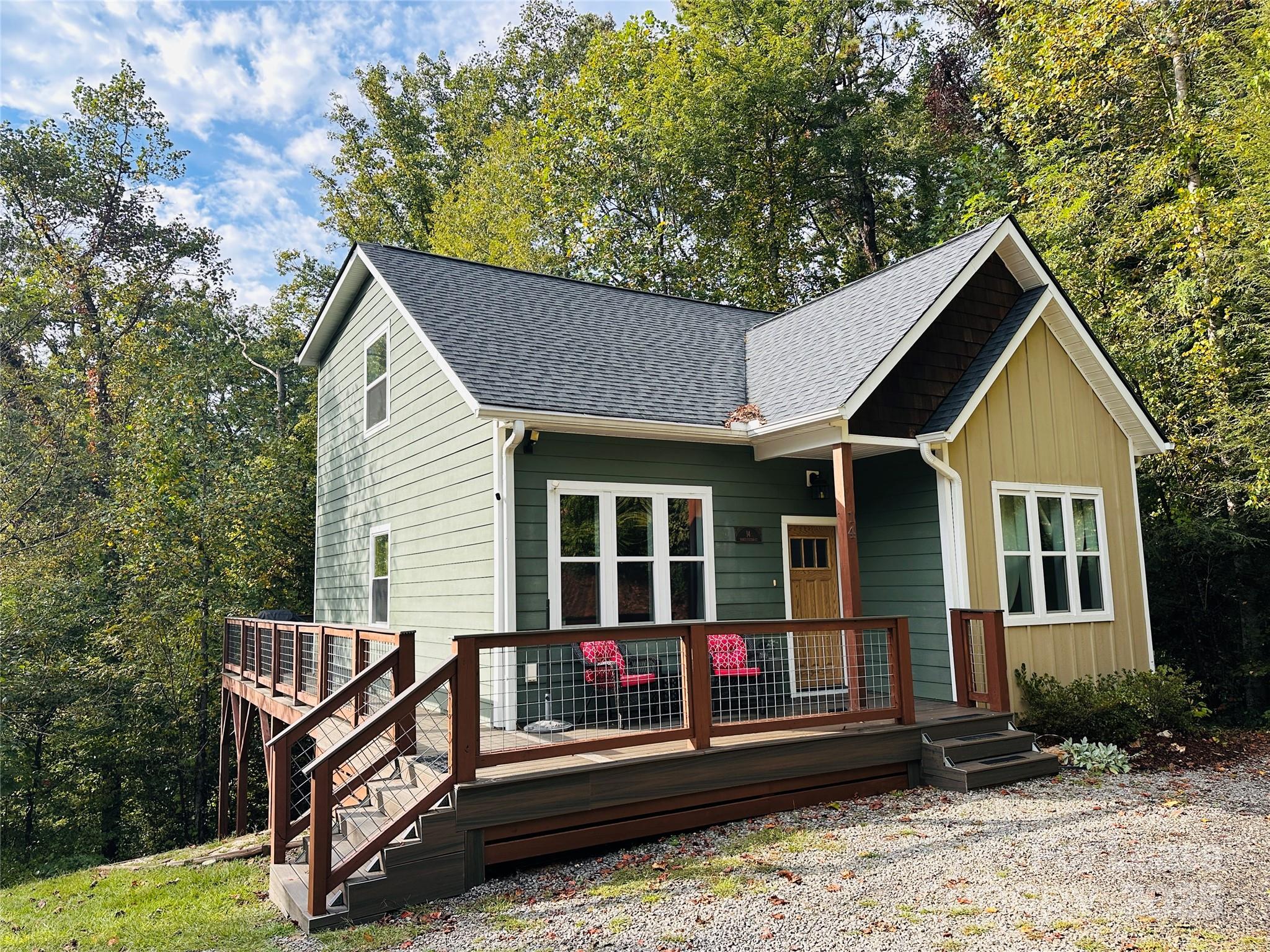 a view of a house with a small yard and wooden fence