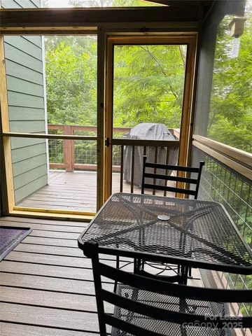a view of a balcony with floor to ceiling windows with wooden floor