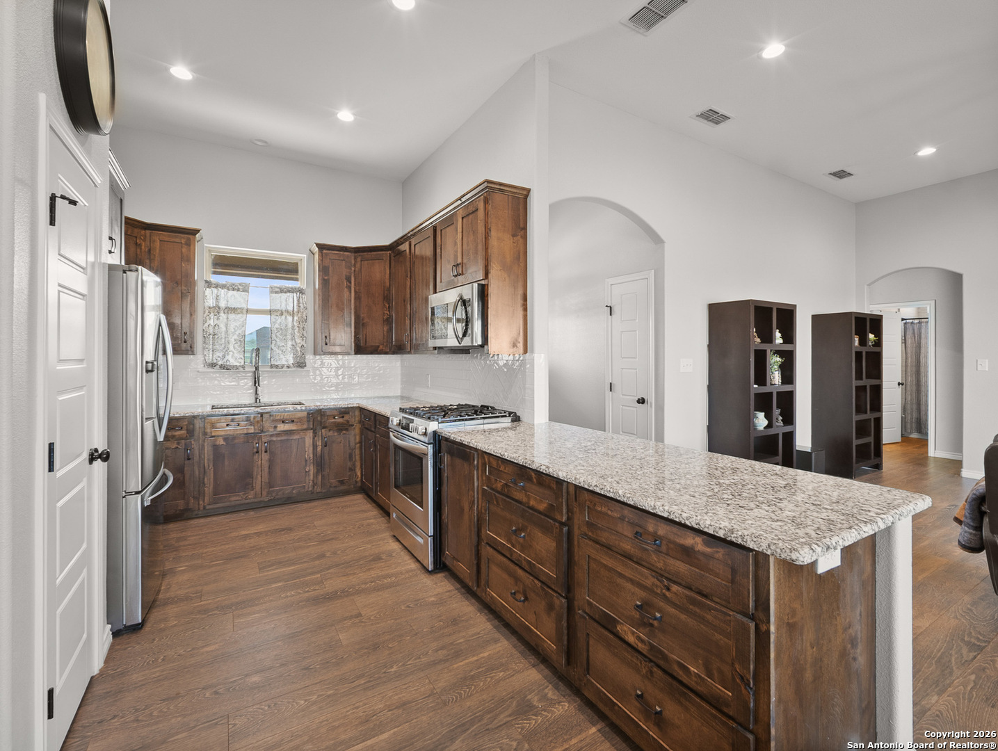 1712 Vista View Drive Pleasanton, TX 78064 - Photo 11 of 37 a large kitchen with stainless steel appliances a refrigerator and wooden cabinets