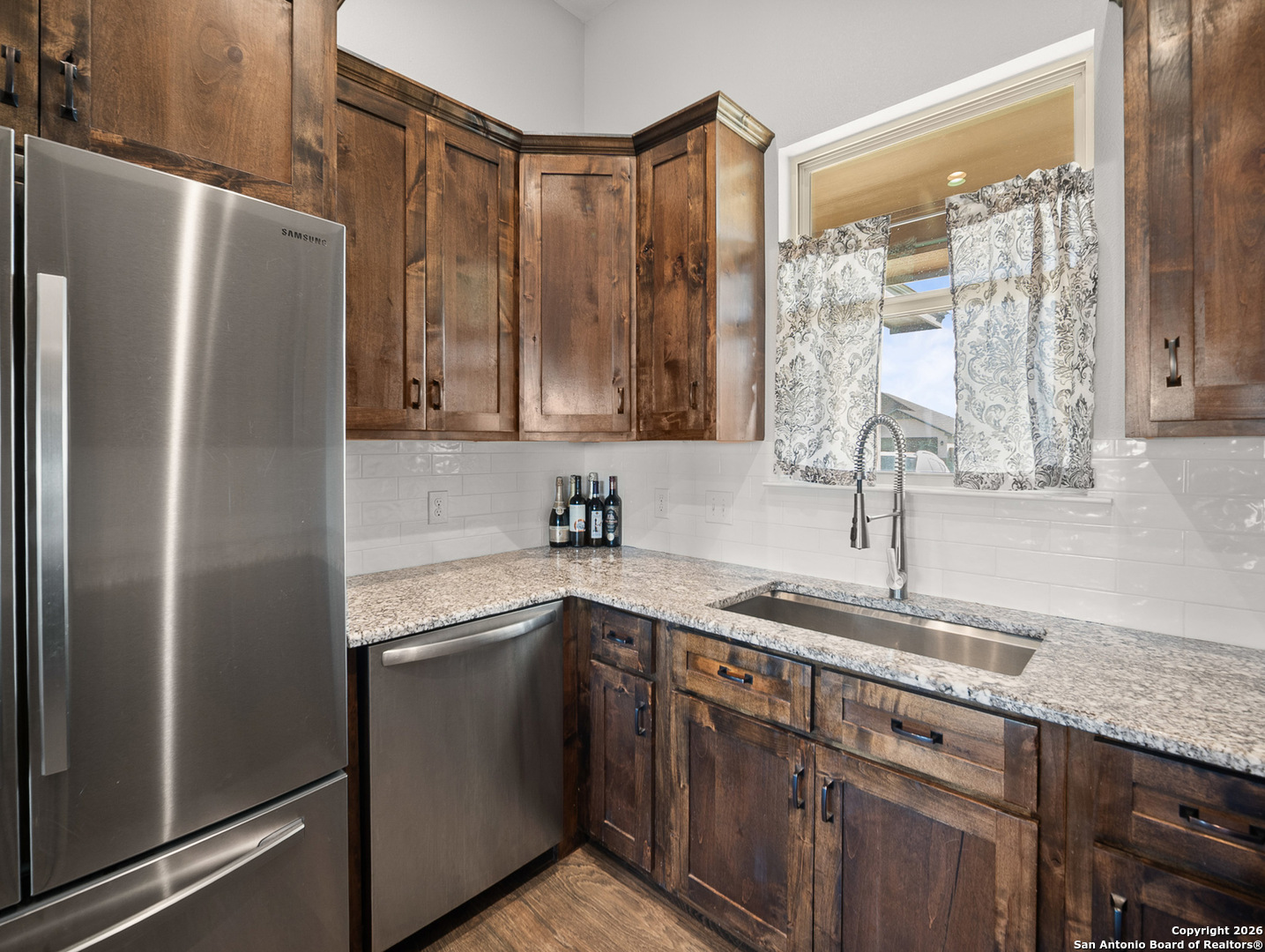 1712 Vista View Drive Pleasanton, TX 78064 - Photo 12 of 37 a kitchen with stainless steel appliances granite countertop a sink and a refrigerator
