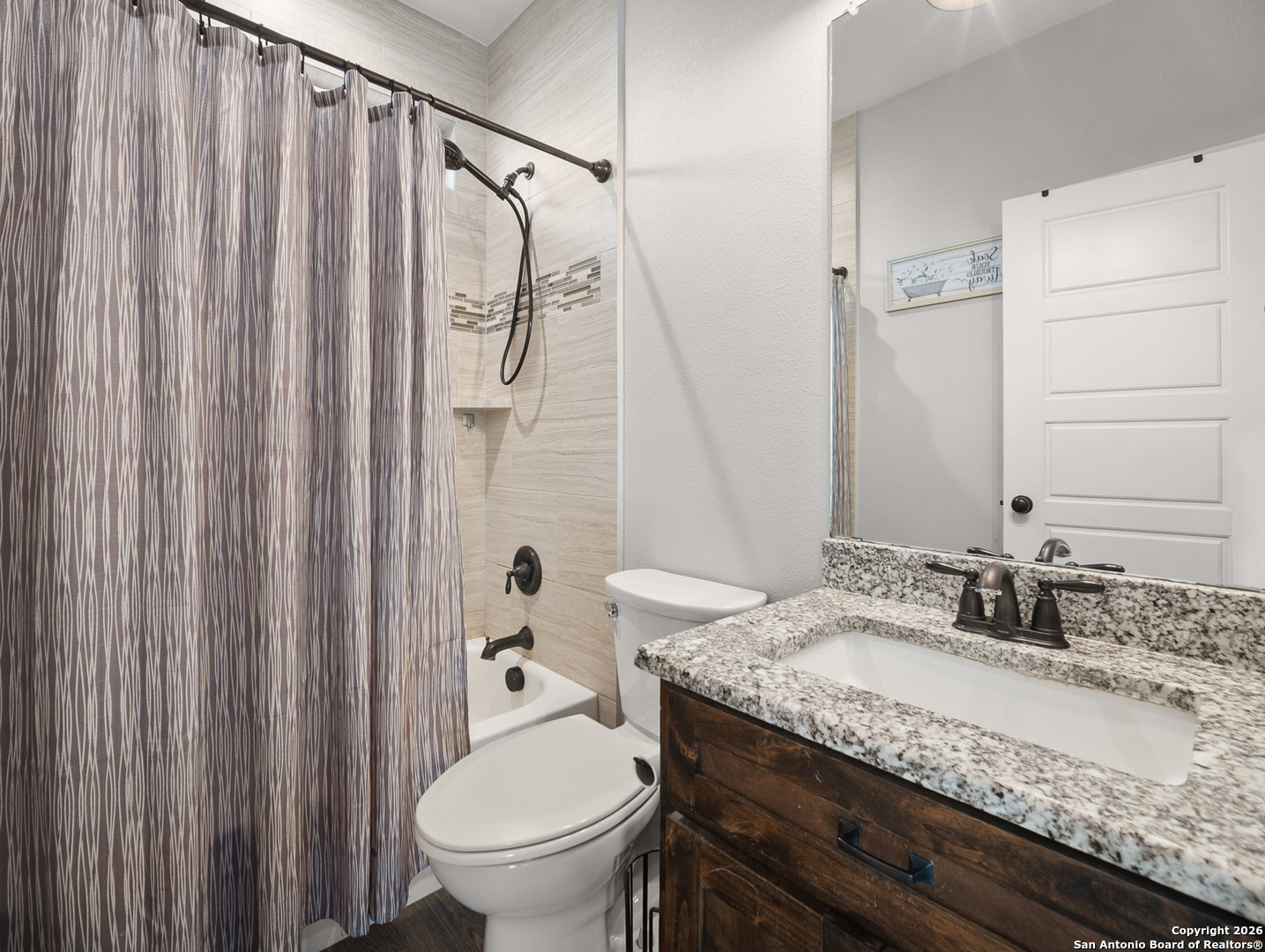 1712 Vista View Drive Pleasanton, TX 78064 - Photo 14 of 37 a bathroom with a granite countertop sink toilet and shower