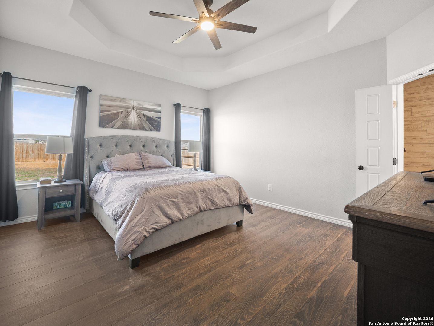 1712 Vista View Drive Pleasanton, TX 78064 - Photo 17 of 37 a bedroom with a bed and a table with wooden floor