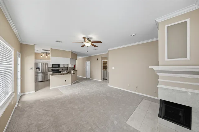 a view of kitchen with sink microwave and cabinets
