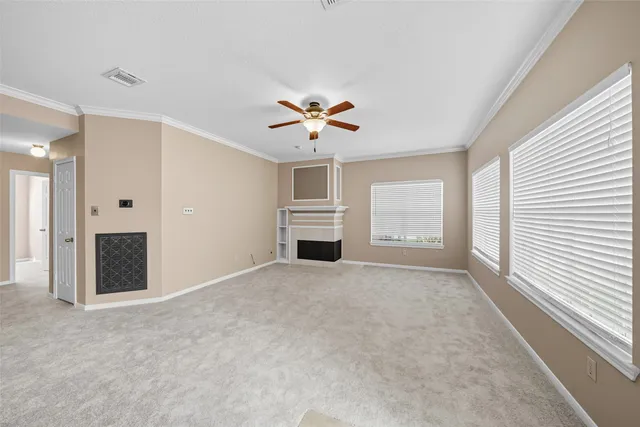 a view of a livingroom with a ceiling fan and window