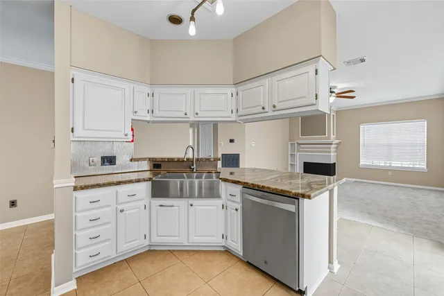 a kitchen with granite countertop white cabinets and white appliances