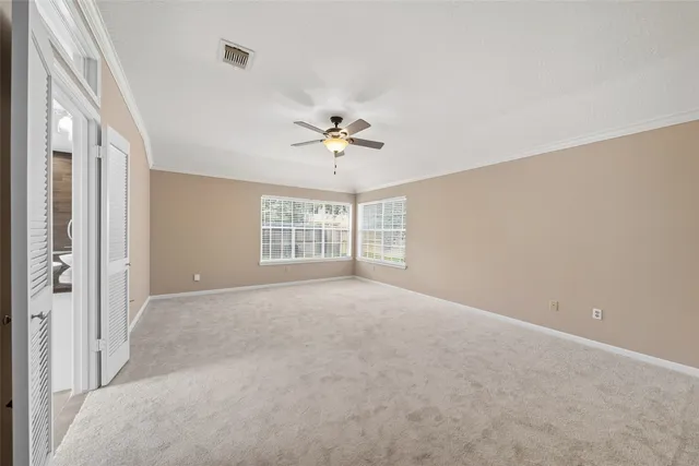 a view of an empty room with a ceiling fan