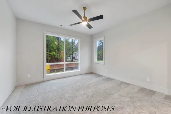 an empty room with ceiling fan and window