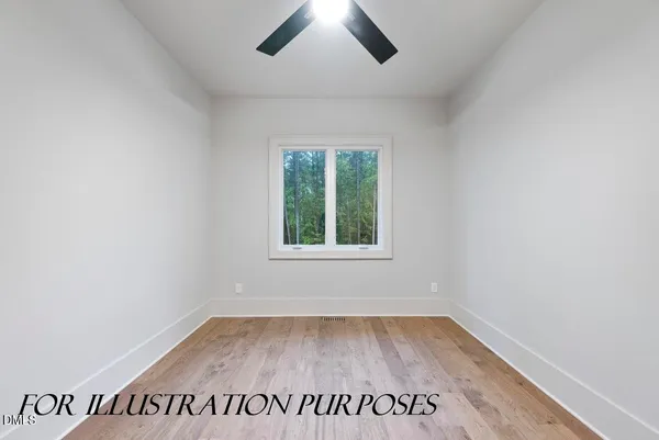 an view of an empty room with wooden floor and window