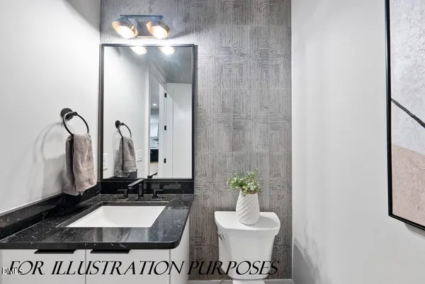 a bathroom with a granite countertop sink a toilet and a mirror