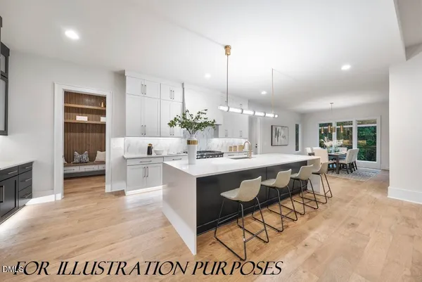 a large kitchen with kitchen island a sink table and chairs