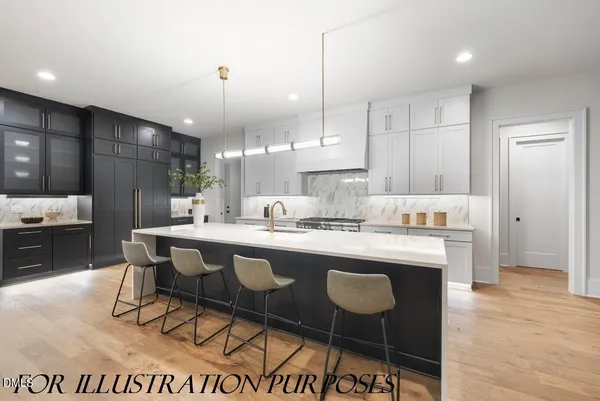 a kitchen with kitchen island granite countertop a sink and refrigerator