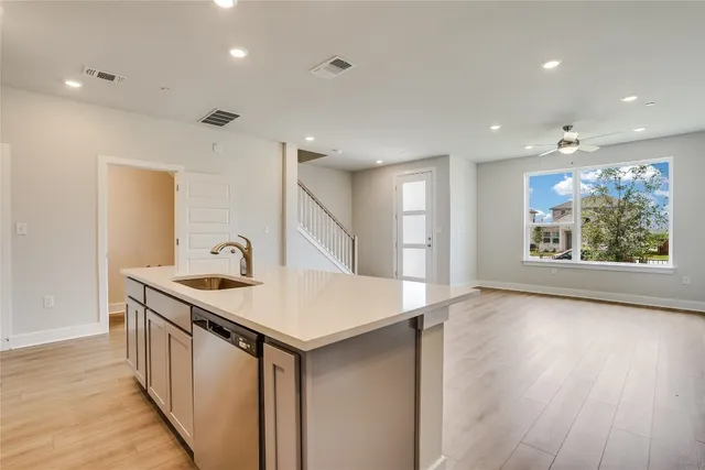 a kitchen with stainless steel appliances granite countertop a white stove top oven and a refrigerator with wooden floor