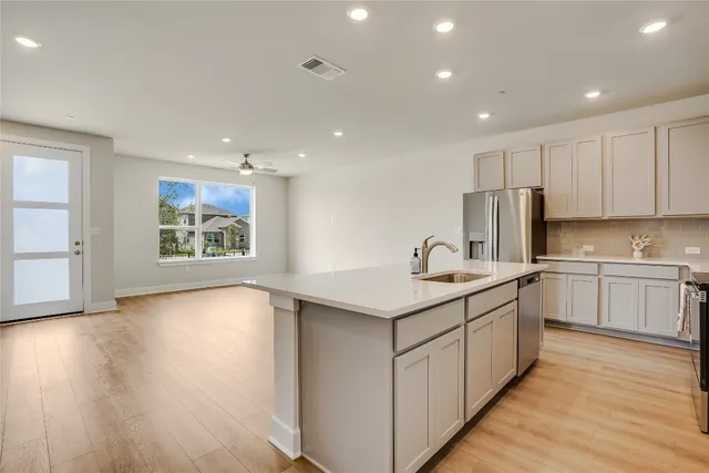 a kitchen with stainless steel appliances granite countertop a sink and cabinets