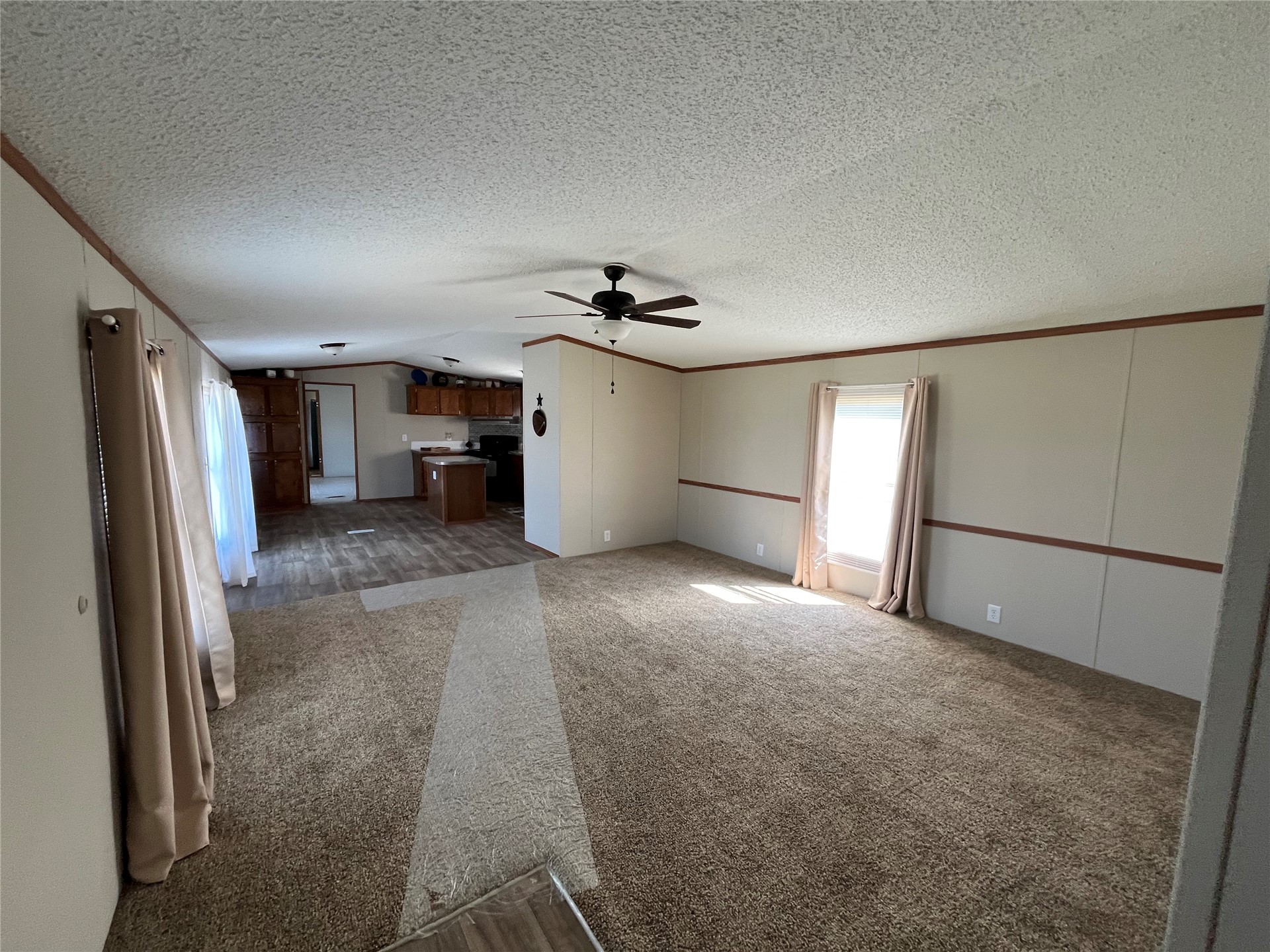428628 East 1133 Road Porum, OK 74455 - Photo 5 of 16 Spacious room with carpet flooring, a ceiling fan, and multiple windows