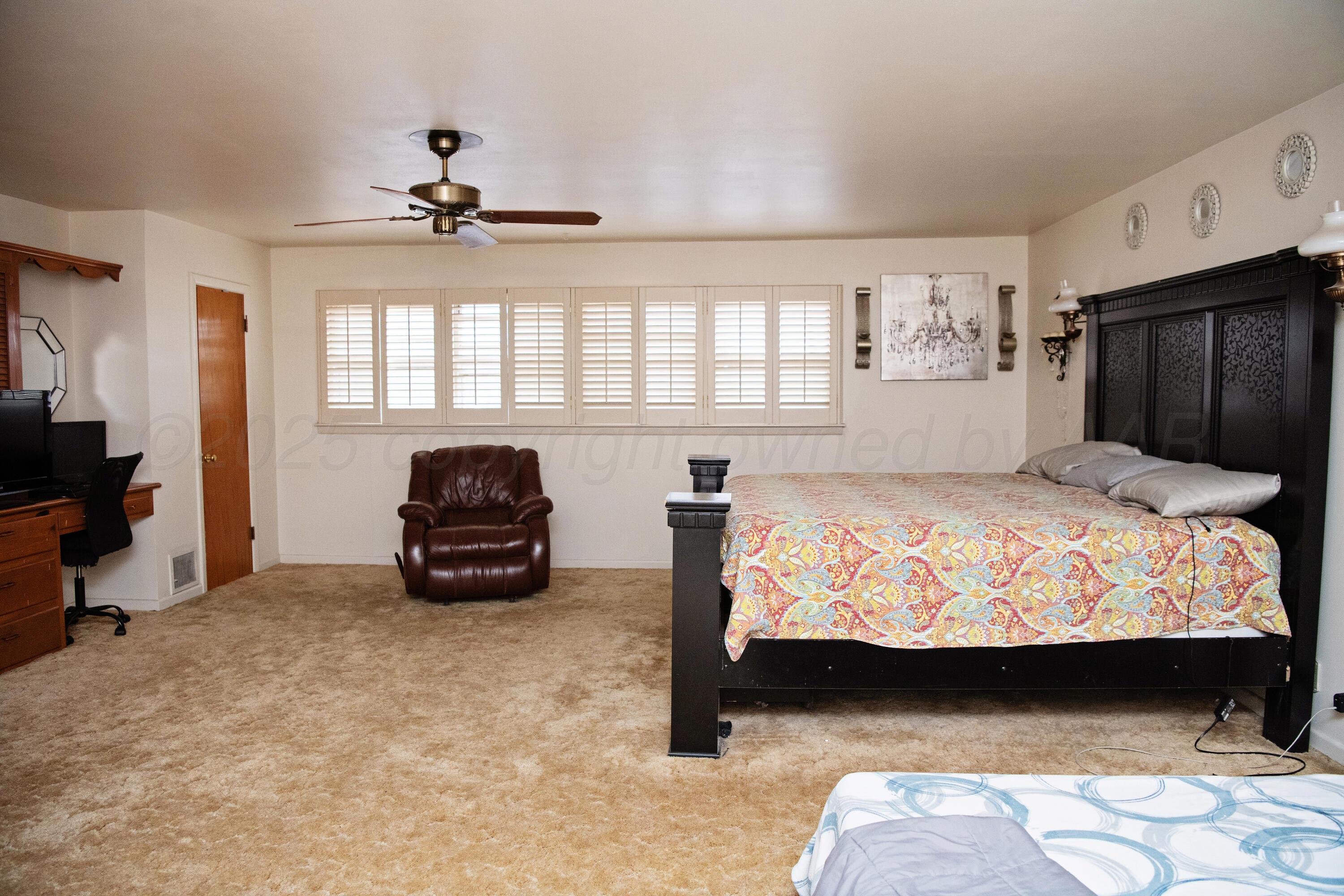 418 Star Street Hereford, TX 79045 - Photo 13 of 17 a bed sitting in a bedroom next to a window