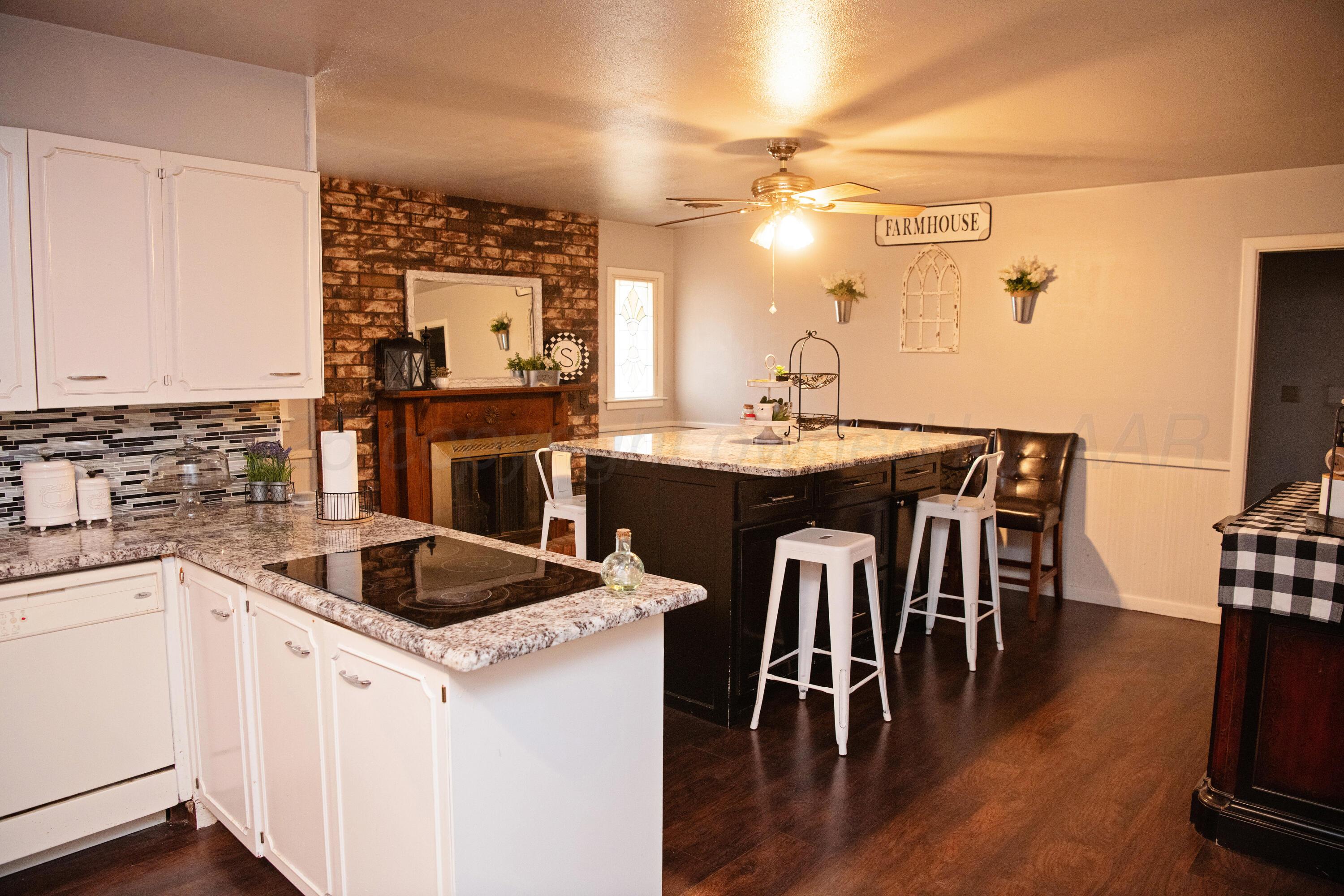 418 Star Street Hereford, TX 79045 - Photo 3 of 17 a kitchen with a table chairs stove and cabinets