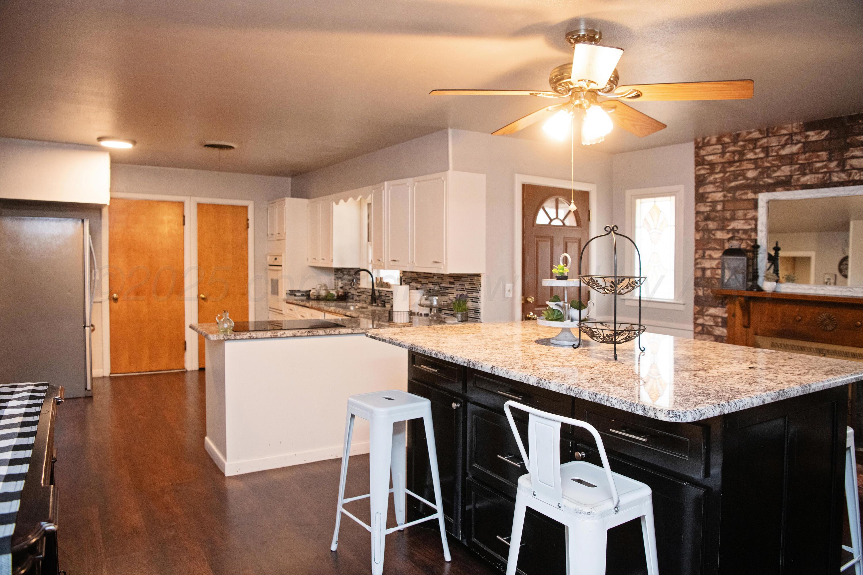 418 Star Street Hereford, TX 79045 - Photo 7 of 17 a kitchen with a dining table chairs sink and cabinets