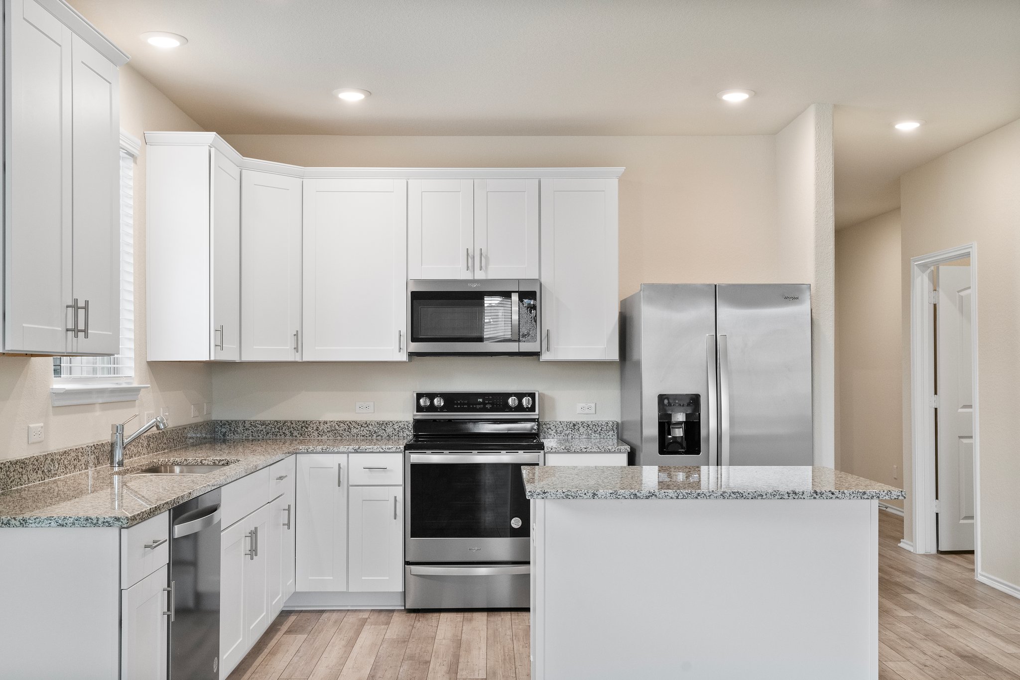 141 Onna Street Taylor, TX 76574 - Photo 10 of 26 a kitchen with stainless steel appliances granite countertop a refrigerator sink and stove