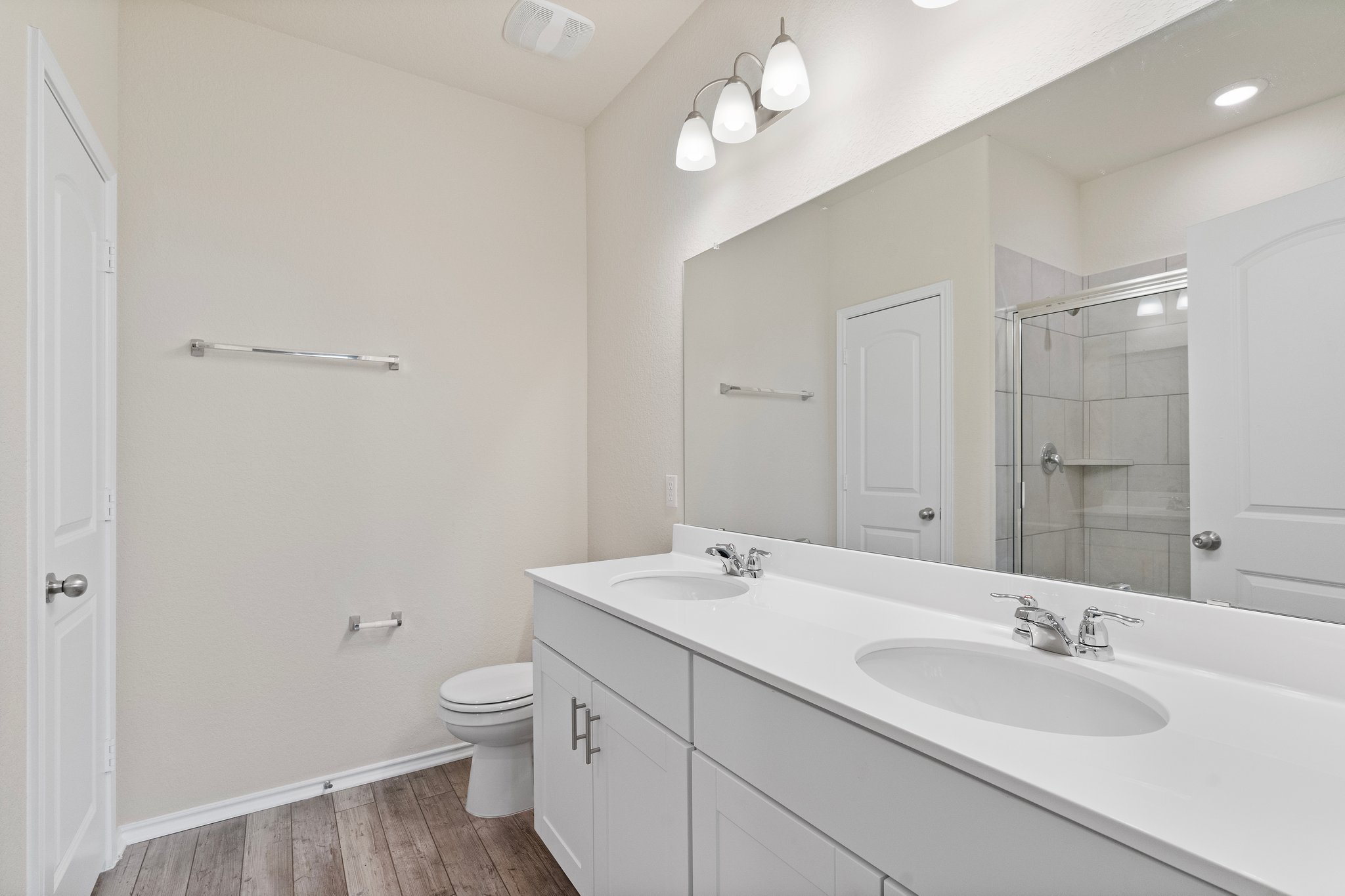 141 Onna Street Taylor, TX 76574 - Photo 17 of 26 a bathroom with a granite countertop sink a toilet and a mirror