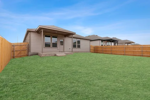 a backyard of a house with lots of green space