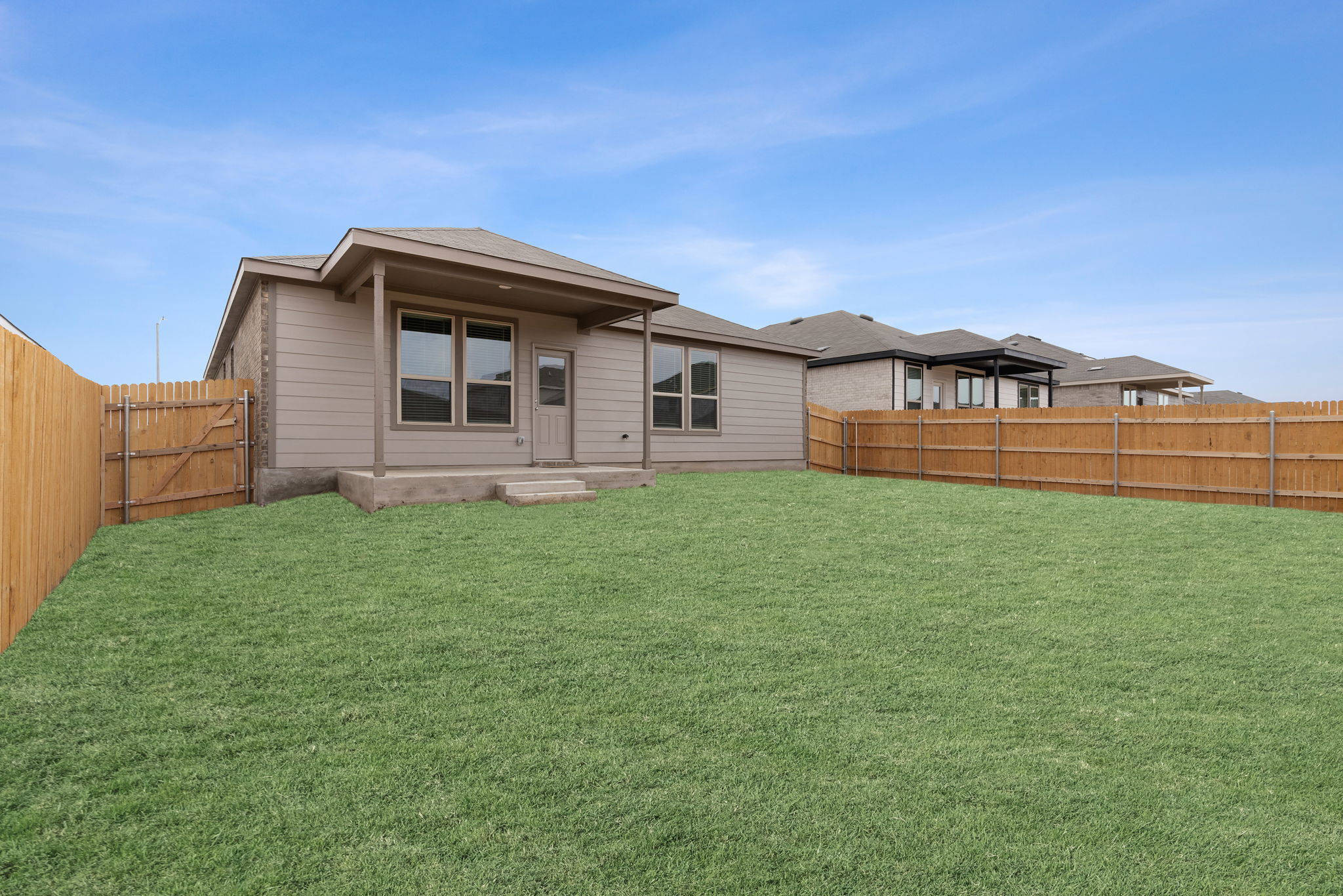 141 Onna Street Taylor, TX 76574 - Photo 24 of 26 a backyard of a house with lots of green space