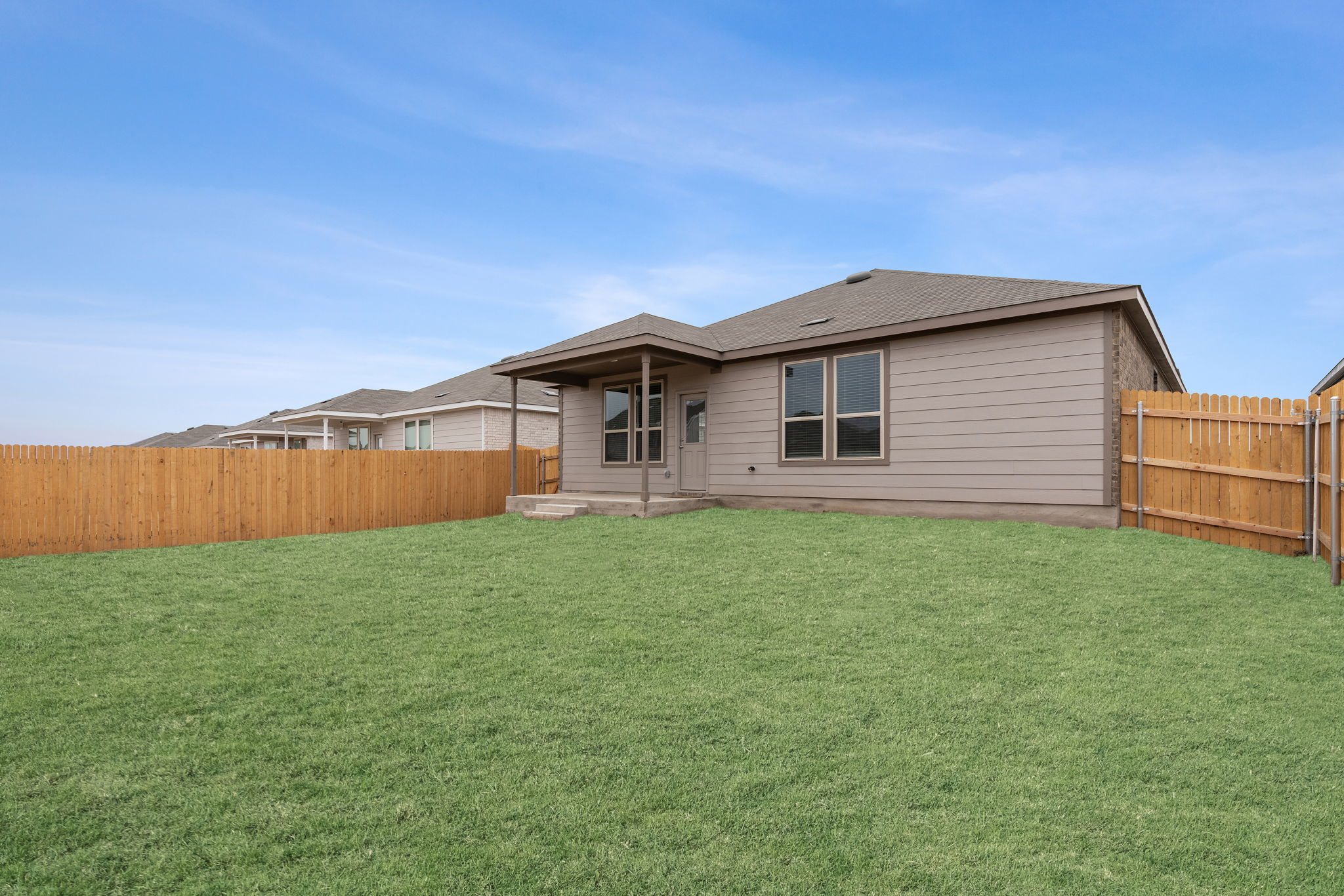 141 Onna Street Taylor, TX 76574 - Photo 25 of 26 a backyard of a house with lots of green space