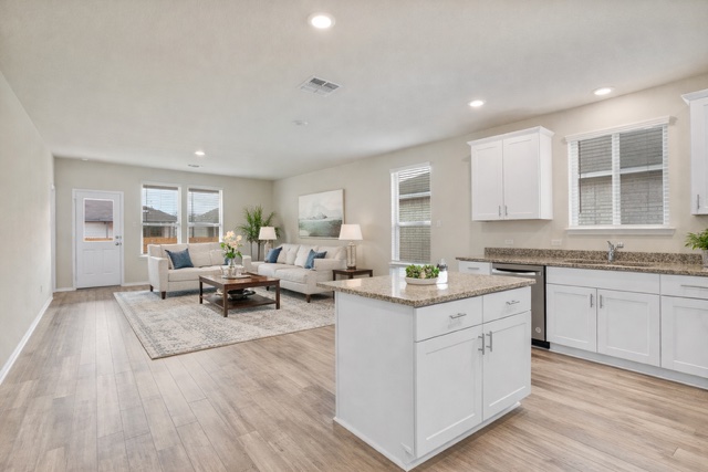 141 Onna Street Taylor, TX 76574 - Photo 26 of 26 a living room with stainless steel appliances granite countertop furniture and a wooden floor